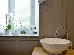 a bathroom with a bowl sink and a window at Darroch View in Ballater