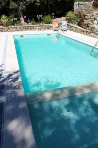 a blue swimming pool with a chair next to it at One bedroom appartement with shared pool and wifi at Marco de canaveses in Marco de Canaveses