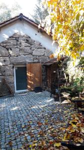 a stone building with a door and a ladder at One bedroom appartement with shared pool and wifi at Marco de canaveses in Marco de Canaveses