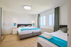 a bedroom with two beds and a window at Hotel Sonnenberg in Luzern