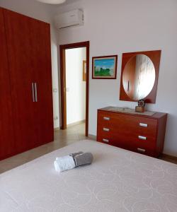 a bedroom with a bed with a mirror and a dresser at Little House in San Salvo