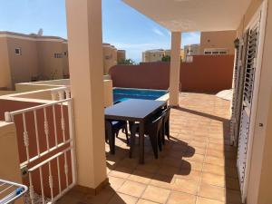 patio con mesa y sillas en el balcón en Casa Mariben, Vacation Rental home Vv 3 Bedrooms private pool with sea views, en Callao Salvaje