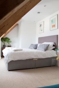 a bedroom with a large bed in a attic at Sleeps 16 with style and space- and a hot tub! in Newquay