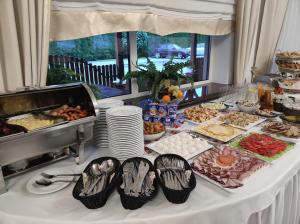 a buffet of food on a white table at Hotel nad Rabą - Bochnia in Bochnia