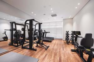 a gym with several treadmills and exercise bikes at Citadines Connect Hari Busan in Busan