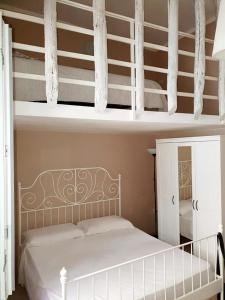 a bedroom with a white bunk bed in a room at Appartamenti della Rotonda in Catania