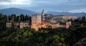 a large castle on top of a hill with trees at Victoria loft in Castell de Ferro