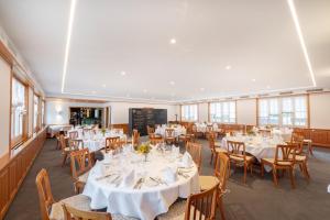 a dining room with white tables and chairs at Landgasthof Wartegg in Wigoltingen