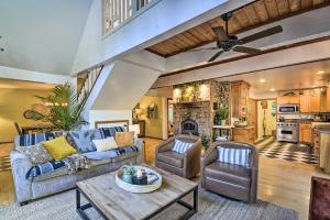 a living room with a couch and a table at 100-Year-Old Farmhouse with Hot Tub on 5 Acres! in Lakebay