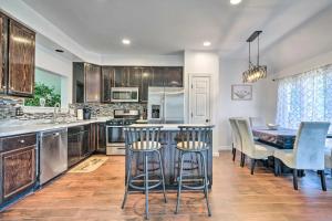 a kitchen with a table and chairs and a kitchen with a counter at Woodbridge Townhome with Pool Table, Pond Views in Woodbridge