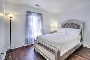 a white bedroom with a bed and a window at Woodbridge Townhome with Pool Table, Pond Views in Woodbridge