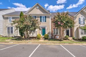 a house with a parking lot in front of it at Woodbridge Townhome with Pool Table, Pond Views in Woodbridge