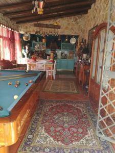 a living room with a pool table and a kitchen at Baglio Zio Ciccio in Altavilla Milicia