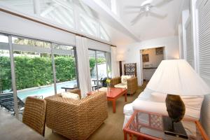 a living room with a couch and chairs and a pool at Simonton Court Historic Inn & Cottages in Key West