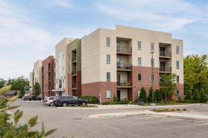 um edifício com carros estacionados num parque de estacionamento em NEW HAPPY TRAIL 2BR CONDO CLOSE TO DOWNTOWN em Traverse City