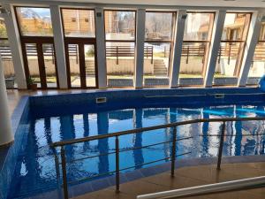 a swimming pool in a building with windows at Mountain View Resort - Apartment B45 in Bansko