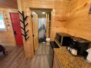 a kitchen with a stove and a microwave in a cabin at Newly Remodeled Motel in Gatlinburg! in Gatlinburg