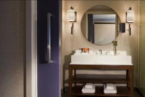 a bathroom with a sink, mirror, and toilet at Kimpton Hotel Palomar Phoenix Cityscape, an IHG Hotel in Phoenix