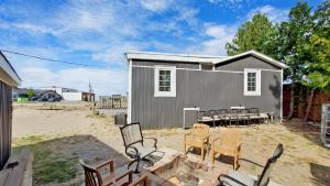 a shed with chairs and a table and chairs at Main Beach River Retreat - Wasaga Beach 1 - Main Strip - 93 Mosley St in Wasaga Beach