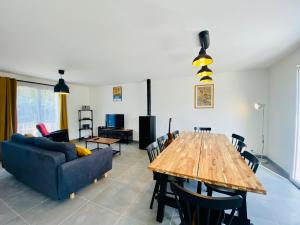 a living room with a wooden table and a couch at Maison ZETNA ,3 chambres et jardin,Penecam ,Le Palais in Le Palais