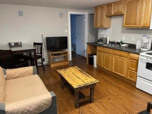 a kitchen with a couch and a table in a room at Rivers End Motel in Corner Brook