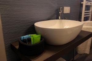 a white bowl sink on a counter in a bathroom at Appartamento La Rosa Dei Venti in Civitanova Marche +8 photos