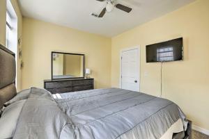 a bedroom with a bed and a mirror and a ceiling fan at Philly Townhome with Gas Grill about 5 Mi to Dtwn! in Philadelphia