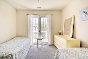 a bedroom with two beds and a dresser with a mirror at Ocean City Family Getaway about Qtr-Mi to Beach! in Ocean City