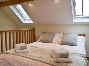 a bedroom with a bed with two pillows on it at The Old Pump House - Uk34451 in Child Okeford