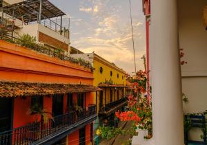 a group of buildings with flowers on the balconies at Casa Rosa - Alma Hotels in Santa Marta