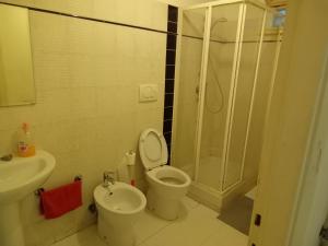 a bathroom with a shower and a toilet and a sink at Cristina room in Lido di Ostia