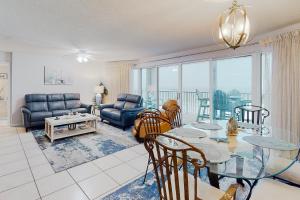 a living room with a glass table and chairs at Long Beach Resort #T2-304 in Panama City Beach