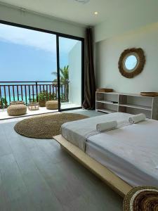 a bedroom with a large bed and a large window at Samura Panorama Guest House in Thulusdhoo