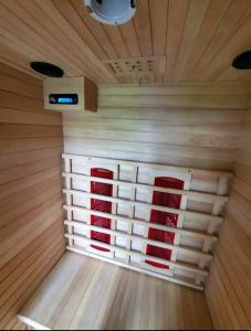 a room with a sauna with red and white panels at Wildwood Camper De Sleeps 6-7, in Dover