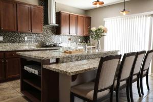 a kitchen with a large island with chairs around it at Cheerful 4 Bedroom Entire House Lots Of Open Space 