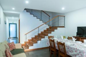 a dining room with a table and a staircase at Sailorman and Friends in Ponta Delgada
