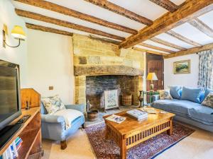 a living room with a couch and a fireplace at Pinley Hill House in Shrewley