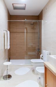 a bathroom with a shower and a toilet and a sink at Sailorman and Friends in Ponta Delgada +25 photos