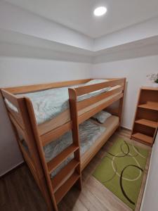 a bunk bed room with two bunk beds and a rug at Apartma Vidovič in Rateče