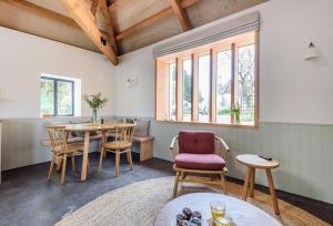 a living room with a table and chairs at Kittwhistle in Dorchester