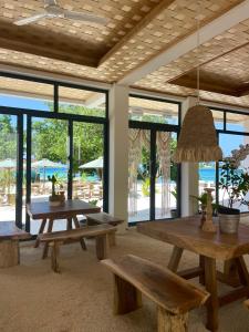 uma sala com bancos, mesas e janelas em Samura Panorama Guest House em Thulusdhoo