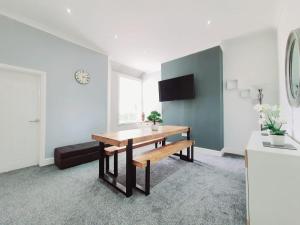 a dining room with a table and a bench at DYSA Bloomfield House in Blackpool