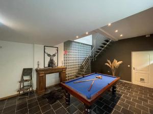 a pool table in a room with a staircase at le gite des chantoires in Aywaille