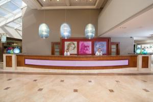 a lobby with two people standing at a counter in a store at Leonardo Plaza Hotel Eilat in Eilat