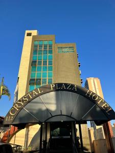 a building with a sign that reads embassy plaza at Crystal Plaza Hotel Marista in Goiânia