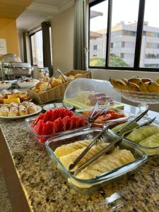 a buffet with many different types of food on a counter at Crystal Plaza Hotel Marista in Goiânia