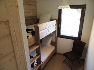 a bunk bed in a tiny house with a chair at T3 aux Gets, vue sur pistes - FR-1-598-5 in Les Gets
