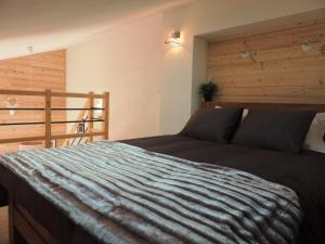 a bedroom with a bed with a wooden wall at T3 aux Gets, vue sur pistes - FR-1-598-5 in Les Gets