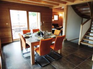 a dining room with a table and orange chairs at Chalet Les Gets, 4 pièces, 6 personnes - FR-1-598-10 in Les Gets