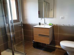 a bathroom with a sink and a shower at Appartement Cosy 3 pièces avec Balcon, Garage et Wi-Fi - FR-1-598-40 in Les Gets +8 photos